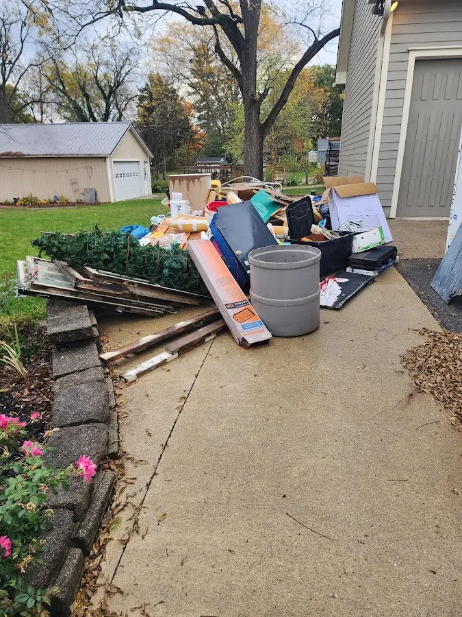 Dumpster being loaded with debris for 12 Yard Dumpster Rental in East Ridge